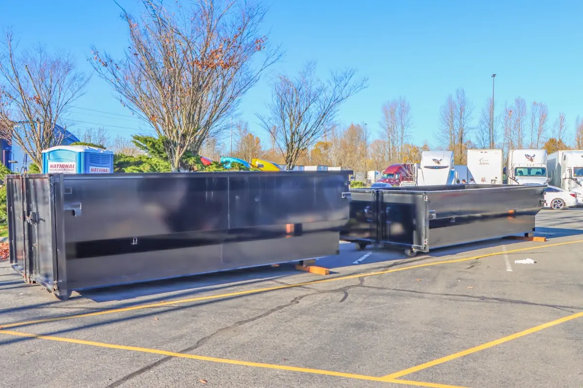 Professional dumpster rental service with roll-off container on residential driveway in Enoch